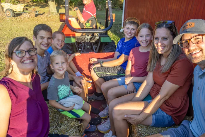 Families on hayride smiling.